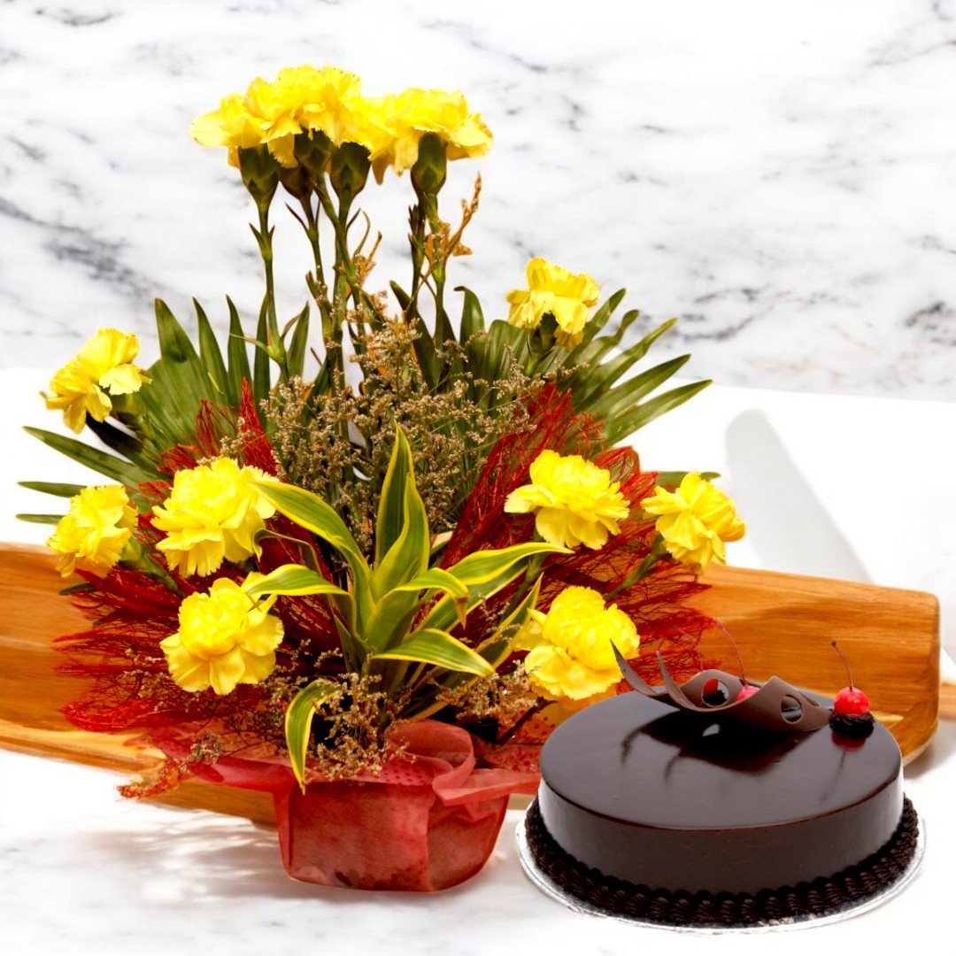 Sparkling Beauty combo of yellow carnations and chocolate truffle cake by BetterGiftFlowers on a wooden table.