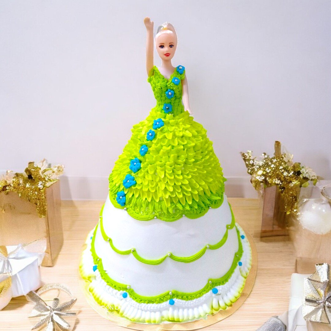 A vibrant green and blue Barbie cake from BetterGiftFlowers, shaped like a Barbie doll with a detailed dress design, perfect for birthdays.