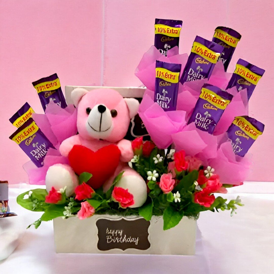 Chocolates N Teddy Box by BetterGiftFlowers with pink teddy and Dairy Milk chocolates arranged in a birthday gift box.