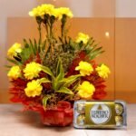 Image of "Carnations And Ferrero" combo by BetterGiftFlowers, featuring a yellow carnation floral arrangement and a Ferrero Rocher chocolate box.