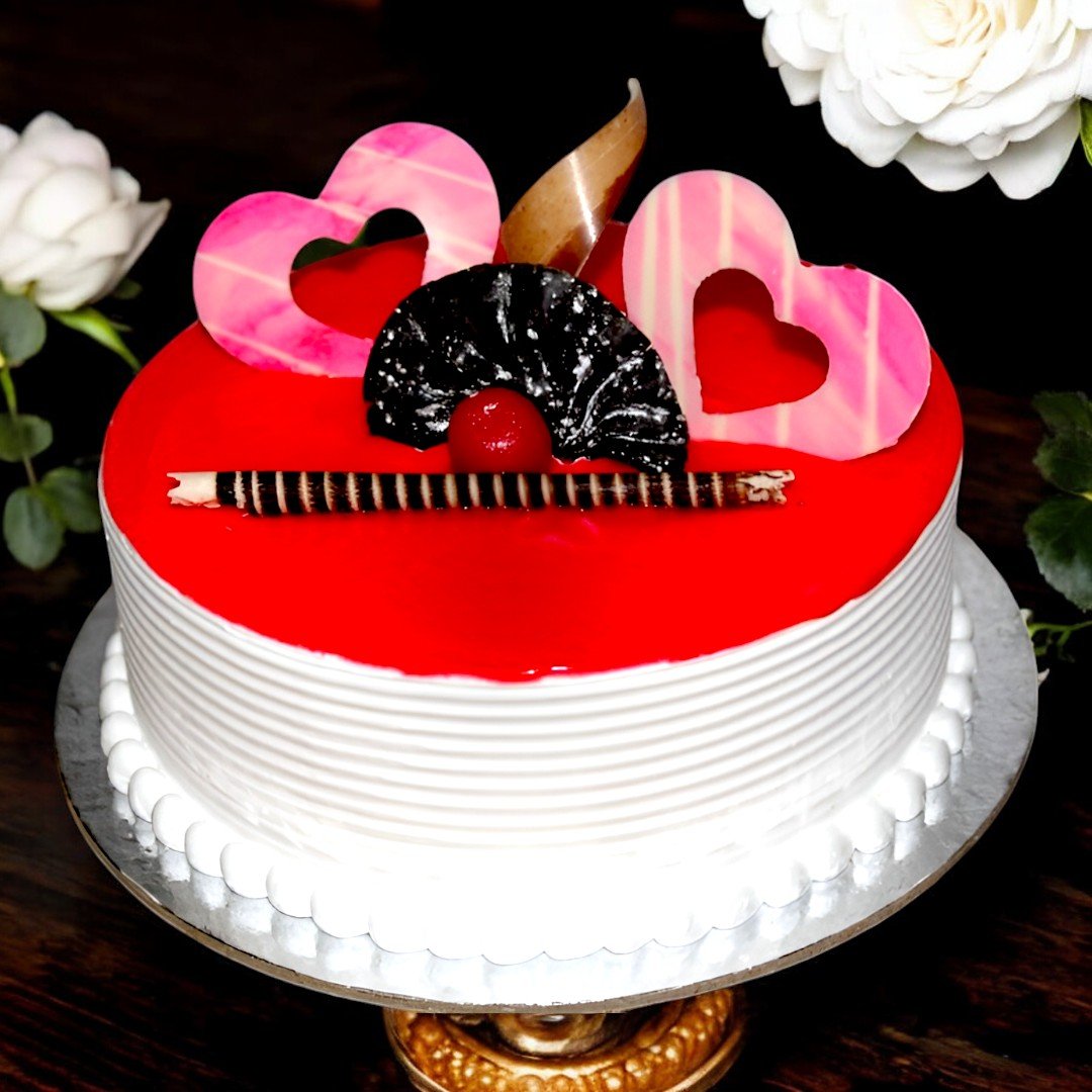 Strawberry Cream Cake by BetterGiftFlowers with pink heart decorations and chocolate garnishes on a white cake base.