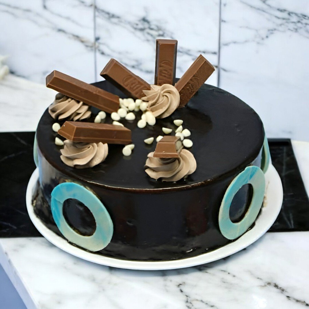 Chocolate KitKat Cake by BetterGiftFlowers with KitKat bars and chocolate curls on top.