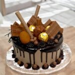 Chocolate Overload Cake topped with assorted chocolates by BetterGiftFlowers