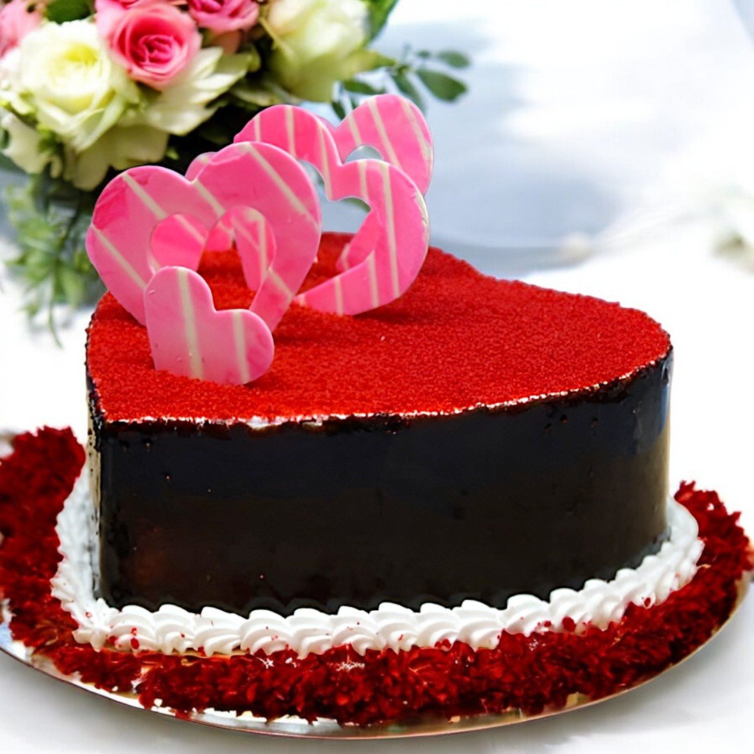 BetterGiftFlowers Red Velvet Heart Shape Cake with pink heart toppers and smooth finish.